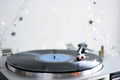 Close-up of vinyl record player, playing Christmas carols. Bokeh lights in the background. - PhotoDune Item for Sale