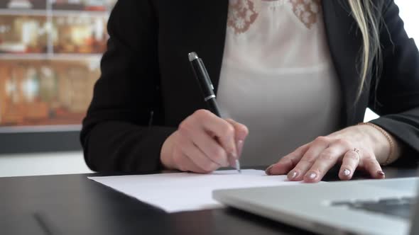 Businesswoman Writing Notes on the Paper
