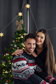 Young couple at home at christmas looking at the camera - PhotoDune Item for Sale