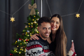 Smiling caucasian couple looking at camera at christmas - PhotoDune Item for Sale