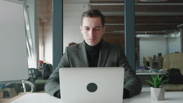 Portrait of Business Man Entrepreneur Typing on Laptop