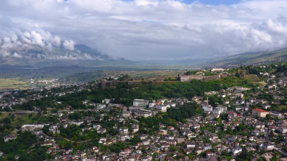 Birds eye view of mountainous landscape with town in the valley. Gjirokaster. Republic of Albania.