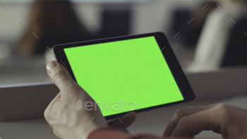  screen. Stock. Chroma key on the screen of the tablet in the hands.