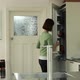 Woman in kitchen putting groceries away - VideoHive Item for Sale