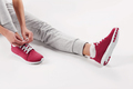 girl tying shoelaces. concept of sport and fitness - PhotoDune Item for Sale