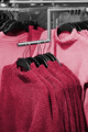 Multo color winter sweater on store shelves. New 2023 trending PANTONE 18-1750 Viva Magenta colour - PhotoDune Item for Sale