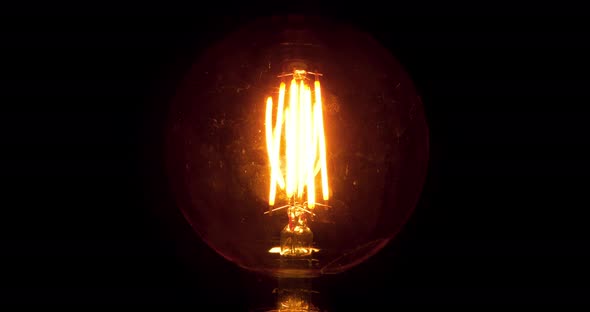 Edison Lamp Flicker At Night. Dirty Light Bulb Glass With Scratches Evokes Horror