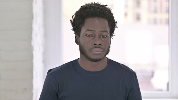 Portrait of Attractive Young African American Man Saying No By Shaking Head