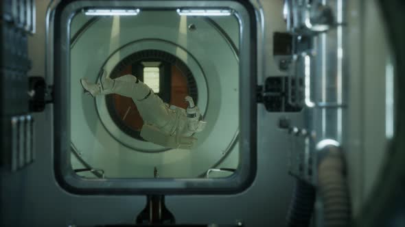 Astronaut Inside the Orbital Space Station alt