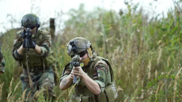 Military Group Walking through Grass