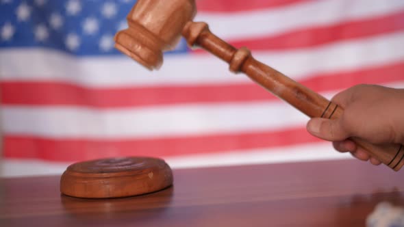 A Judge Gavel with a Flag of United States of America on Background