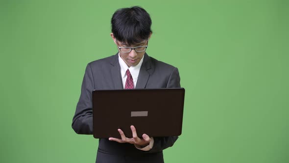 Young Asian Businessman Using Laptop