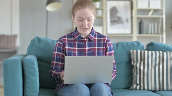 Young Woman Excited While Working on Laptop