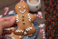 Woman hand holding a gingerbread man cookie - PhotoDune Item for Sale