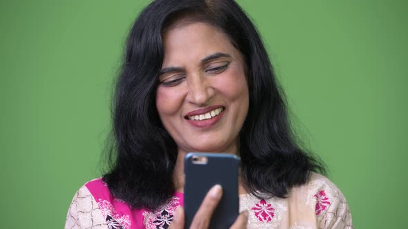 Close Up Shot of Mature Beautiful Indian Woman Using Phone