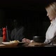 Blonde Girl in a White Shirt Eats a Dish Sitting in a Restaurant - VideoHive Item for Sale