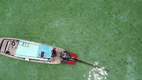 Boatman standing on long-tail boat, Koh Phi Phi Don, Thailand