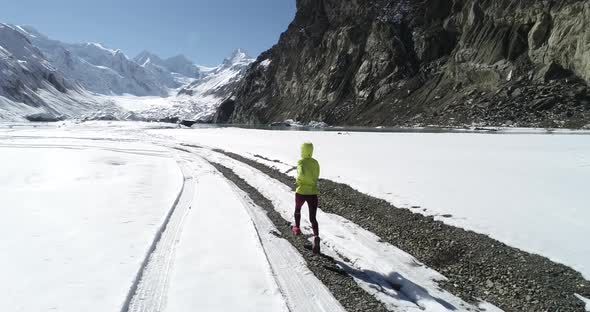 Woman trail runner cross country running in winter nature,Aerial view drone footage 