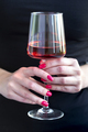Woman holding glass of rose wine, closeup on hands - PhotoDune Item for Sale