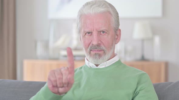 Old Man Saying No with Finger Gesture