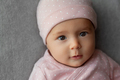 Portrait of newborn baby girl in pink pajamas looking at camera, babyhood and childhood concept - PhotoDune Item for Sale