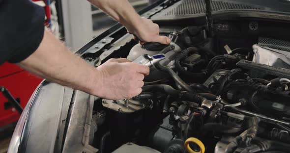 Car Mechanic Checking Antifreeze In The Car. Antifreeze Test