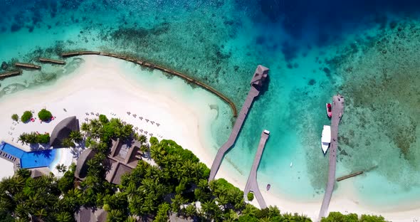 Luxury birds eye clean view of a white sand paradise beach and blue water background in colourful 4K