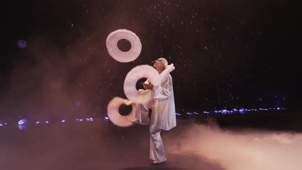 Circus performer juggling with three big white rings, Moscow, Russia