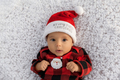 Portrait of infant baby girl dressed in Christmas outfiit looking at camera - PhotoDune Item for Sale