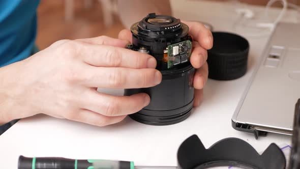 Man Repairs Camera Lens Autofocus Motor Tools