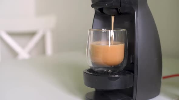 Home making hot cappuccino in coffee machine