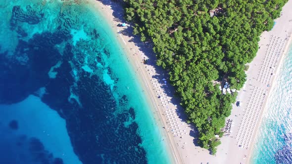 Flying over of the sandy beach Zlatni rat on the island of Brac, Croatia