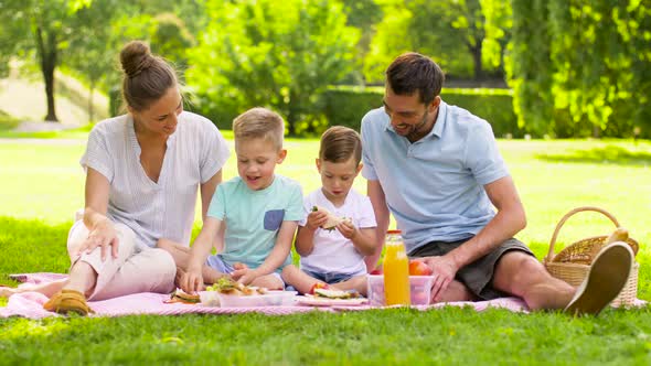 Happy Family Having Picnic at Summer Park