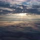 Aerial view, flying above the clouds during sunrise. Scenic view of moving fluffy clouds. - VideoHive Item for Sale