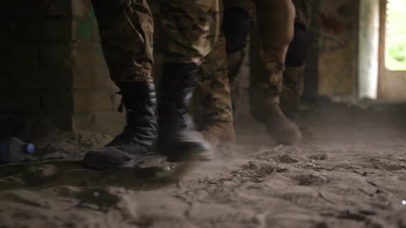 Soldier Legs in Army Combat Boots Walk in Building