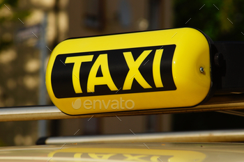 A taxi sign on a taxi