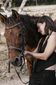 Amazon girl holding the horse's reins and looking at camera. - PhotoDune Item for Sale