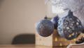 Closeup view of shiny blue holiday baubles hanging on a lower branch of christmas tree - PhotoDune Item for Sale