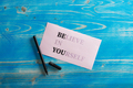 Believe in yourself sign written on pink paper with words BE YOU emphasised more - PhotoDune Item for Sale