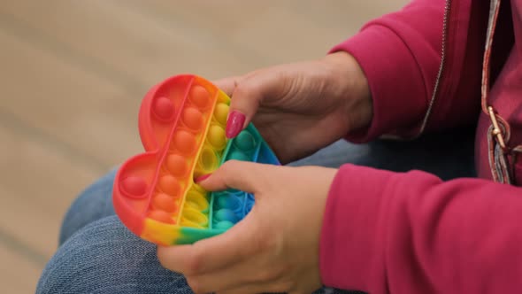 Closeup of Woman Playing with Pop It Toy Fidget