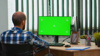 er with chroma key for videomeeting. Handicapped disabled freelancer looking at pc with green screen, mockup, key talking with remotely colleagues