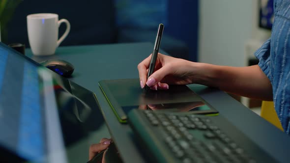 Close Up of Hand Holding Stylus on Graphic Tablet for Retouch Work