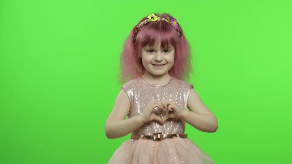 Child Girl Princess Showing Love Heart Sign with Her Hands. Mother's Day Concept