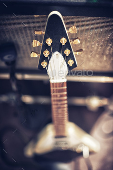  a guitar leaning on an amp