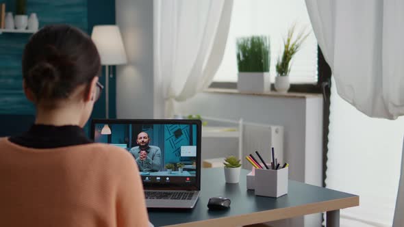 Female Student Attending Online Video Call Conference on Laptop