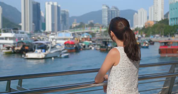 Tourist woman enjoy the view of Hong Kong city with seaside