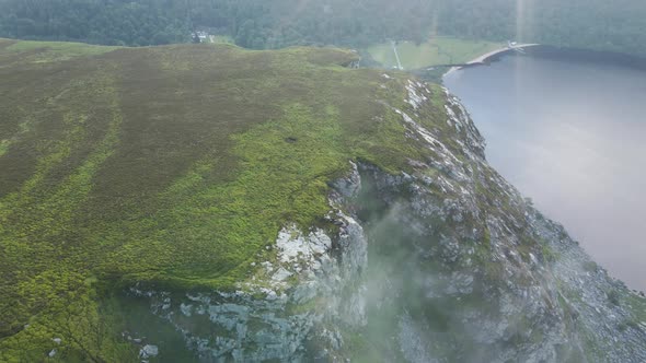 Clouds Stuck On The Rocky Cliff In The Wicklow Mountains With The Scenic Lough Tay, Guinness Lake In