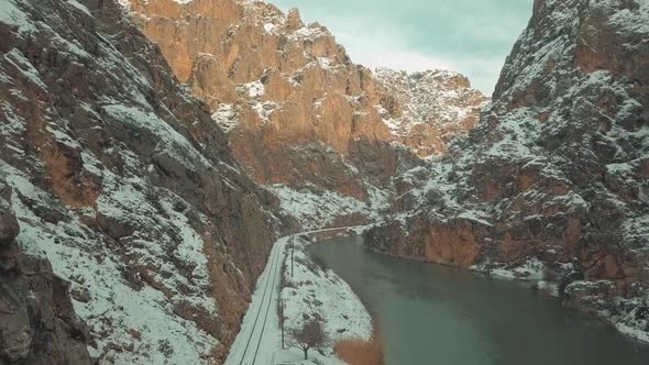 aerial view of train track between mountains