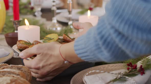 Unrecognizable Woman Setting Dinner Table on Christmas