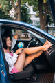 Young woman sitting in a car and holding a globe - PhotoDune Item for Sale